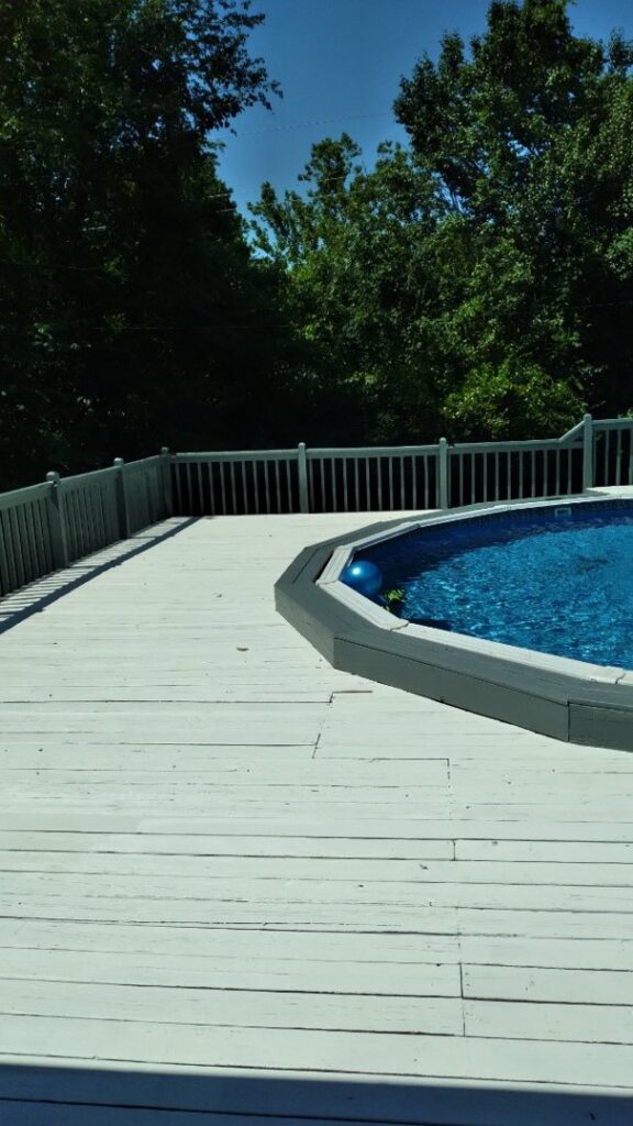 A clean wooden deck surrounding an above-ground swimming pool, showcasing completed deck work by JAMS Property Preservation LLC in Dayton, OH.
