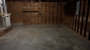 A clean and empty basement or garage with wooden walls, cleared out by 575 Junk Removal in Clovis, NM.
