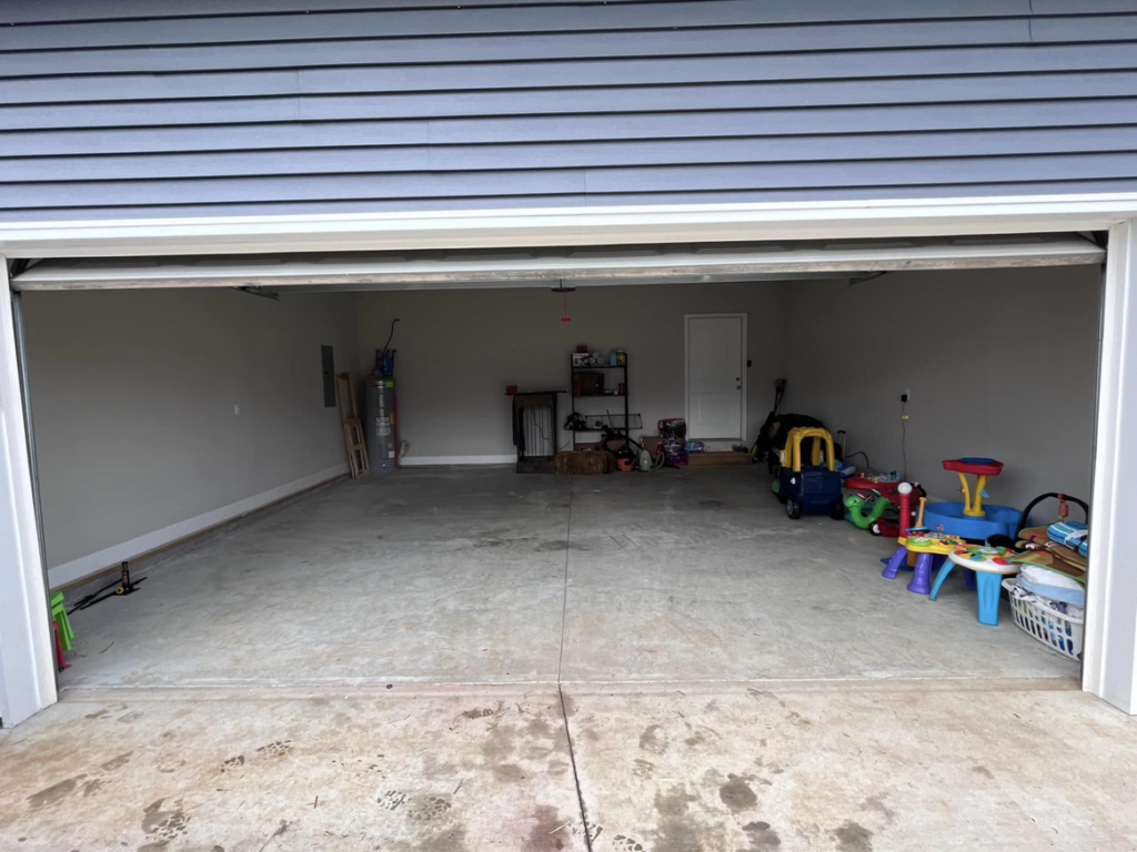 A clean and empty garage after professional junk removal service by Haul It All Debris & Junk Removal in Henderson, NV
