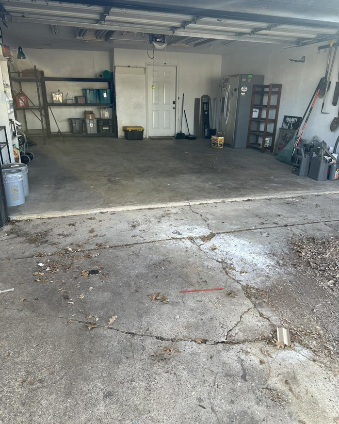 A clean and empty garage after a successful junk removal service by Junked Up Junk Removal in Watauga, TX.