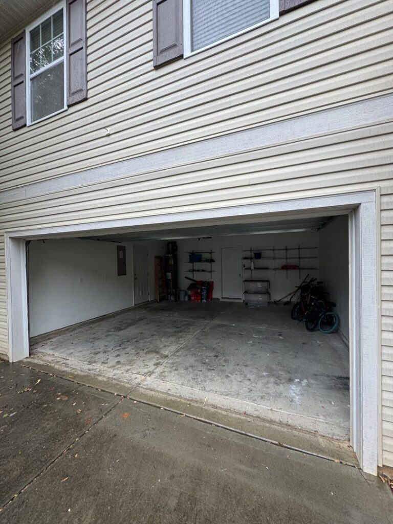 A clean and empty garage after a successful junk removal service by Junkjet in Charlotte, NC.