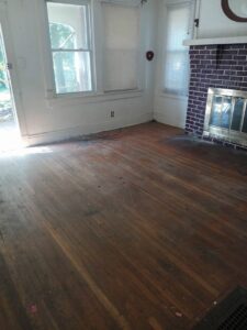 A clean, empty room with hardwood floors and a fireplace, showcasing a completed junk removal service by Music City Removal in Nashville, TN.
