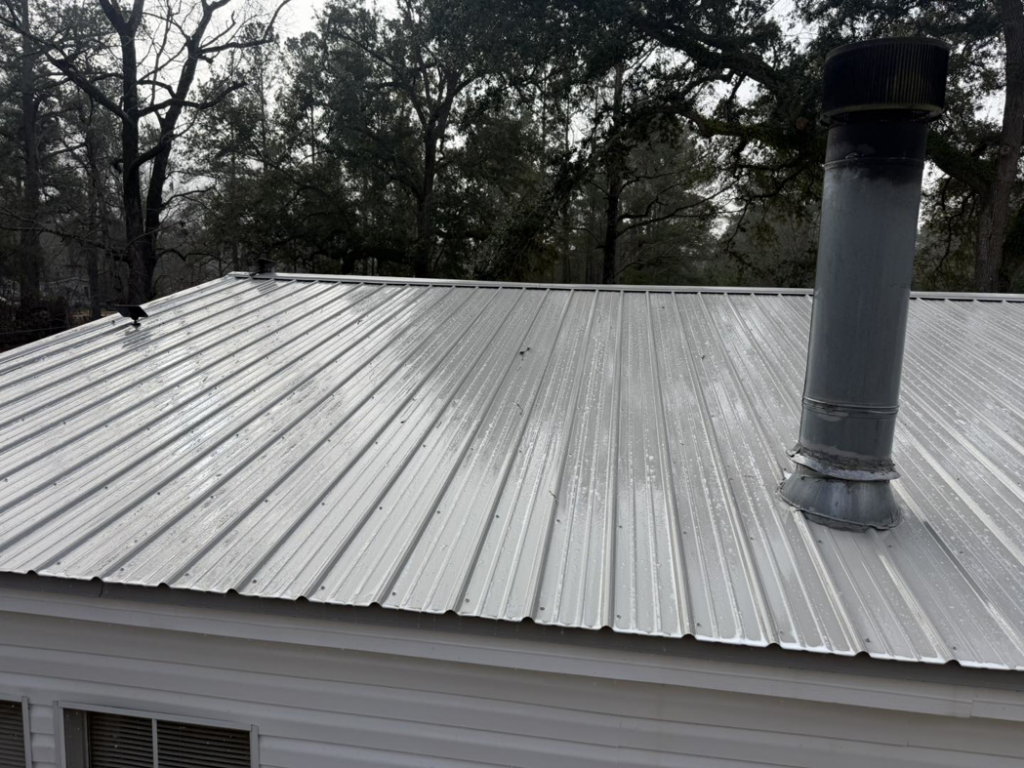 A clean metal roof with a vent pipe, sparkling after a professional wash by Jeff's Exterior Washing in Summerville, SC.
