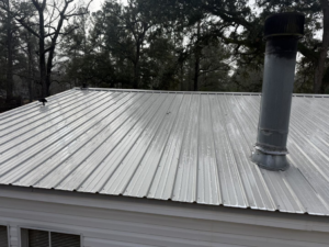A clean metal roof with a vent pipe, sparkling after a professional wash by Jeff's Exterior Washing in Summerville, SC.