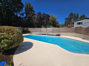 A pristine, newly resurfaced pool deck completed by Done Right Handy, your handyman in Wilmington, DE.