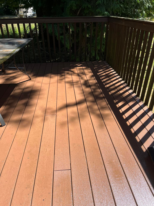 A clean and stained wooden deck with railings, maintained by JJT Construction in Portland, OR.