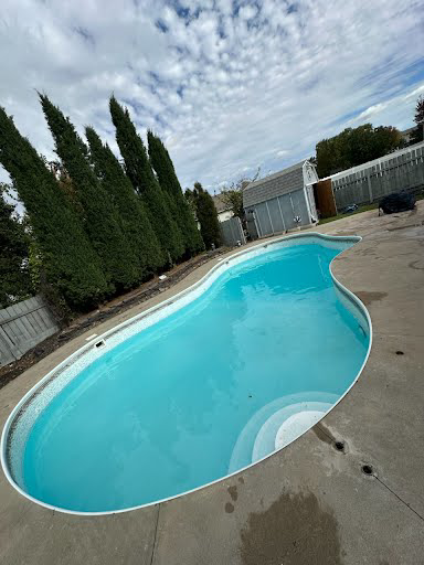 A sparkling clean swimming pool after professional maintenance by Titan Handyman, LLC in Lewes, DE.