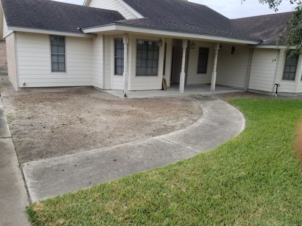 A residential front yard with a cleared area, indicating recent tree removal work by C & N Tree Service in Corpus Christi, TX.