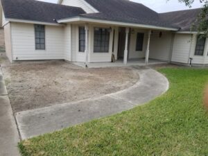 A residential front yard with a cleared area, indicating recent tree removal work by C & N Tree Service in Corpus Christi, TX.