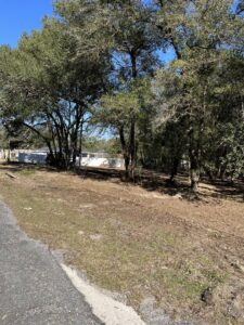 An area after land clearing with some debris remaining, showcasing land management services by DLT Land Management in Tampa, FL.