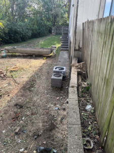 A residential backyard completely cleared of trees and brush, showing the successful result of tree removal service by Hunters Lawn Care & Tree Service in St. Joseph, MO.