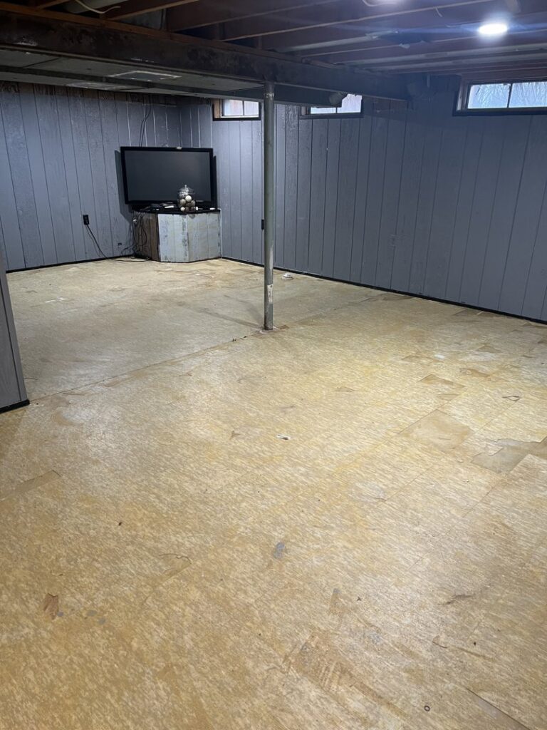 A largely cleared basement space after junk removal services by Prestige Junk Removal & Hauling in Detroit, MI