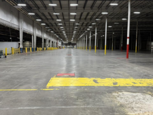 A large, empty industrial warehouse after a professional cleanout by Remove Recycle Remarket in Troy, MI.