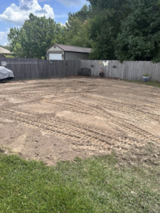 A cleared and leveled backyard area after a successful junk removal job by Weekly Waste Solutions in Jackson, MS.