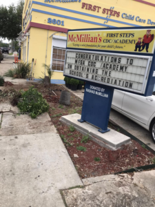 A cleared area with removed vegetation and a tree stump, indicating work by J.Pittman Services in New Orleans, LA.