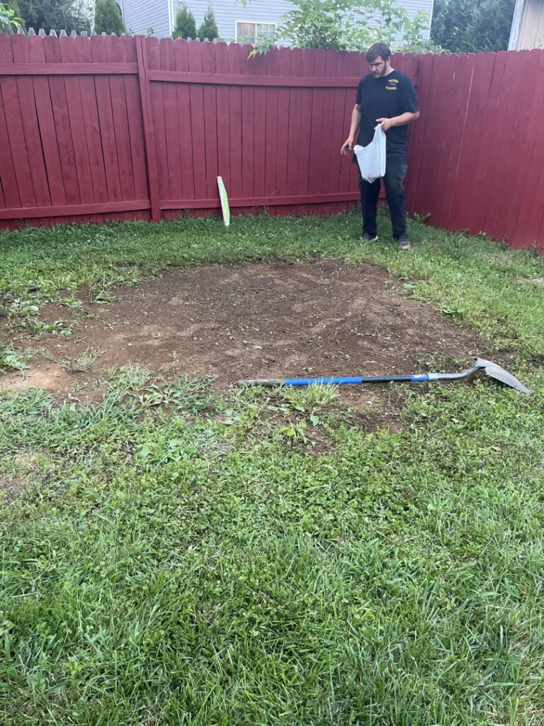 A cleared patch of ground in a backyard after debris removal by Dumpin' Junk in Martinsburg, WV.