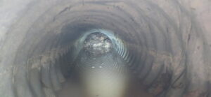 An interior view of a clogged corrugated pipe, inspected by Precision Industrial Maintenance, Inc. in Schenectady, NY.