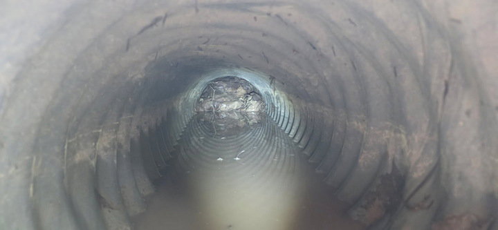 An interior view of a clogged corrugated pipe, inspected by Precision Industrial Maintenance, Inc. in Schenectady, NY.