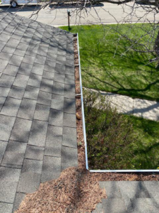 A clogged gutter overflowing with leaves and debris, ready for cleaning by Hey Matt Handyman in Sheridan, WY