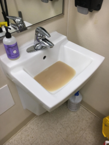 A clogged sink filled with dirty, stagnant water, indicating a plumbing issue for Master Handyman, LLC in Cleveland, OH.