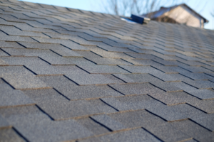 Close-up of dark asphalt shingles on a residential roof, showcasing exterior work by Coburns interior and exterior in Services Available In.