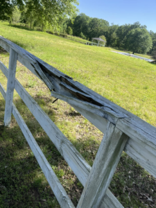 A close-up view of a broken wooden fence, showing damage that S&S Handyman Services can repair in Reno, NV
