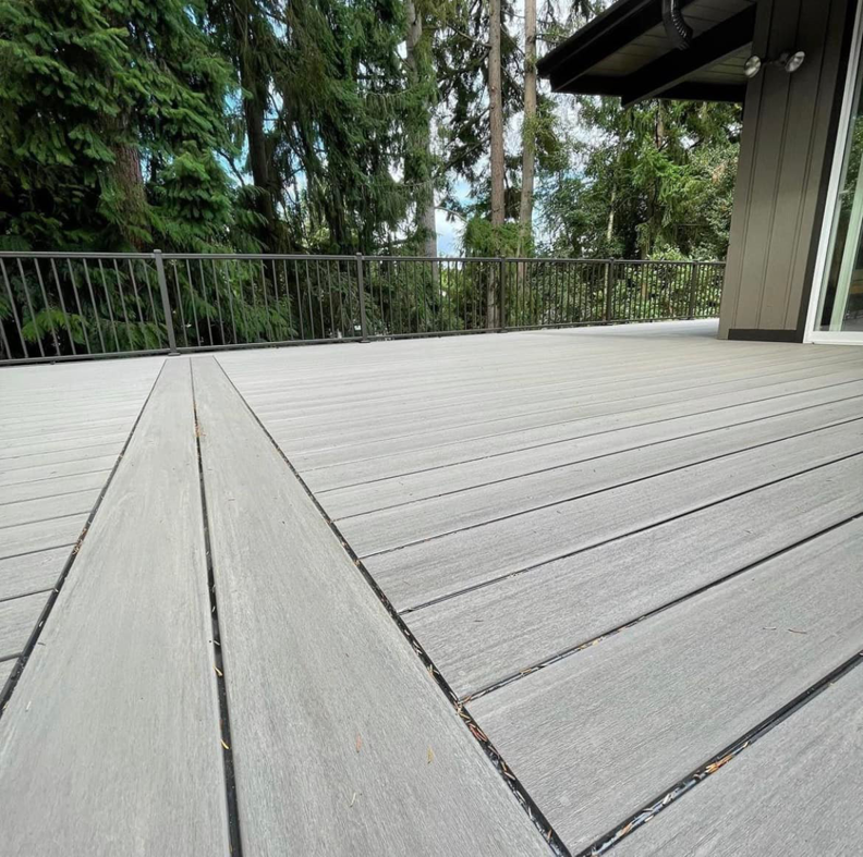 A close-up view of high-quality composite decking installation, demonstrating craftsmanship by Kalau Builders LLC in Eugene, OR.