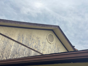 Close-up view of damaged house siding and trim, showing a need for exterior handyman repair by Construction Doctor in Littleton, CO.