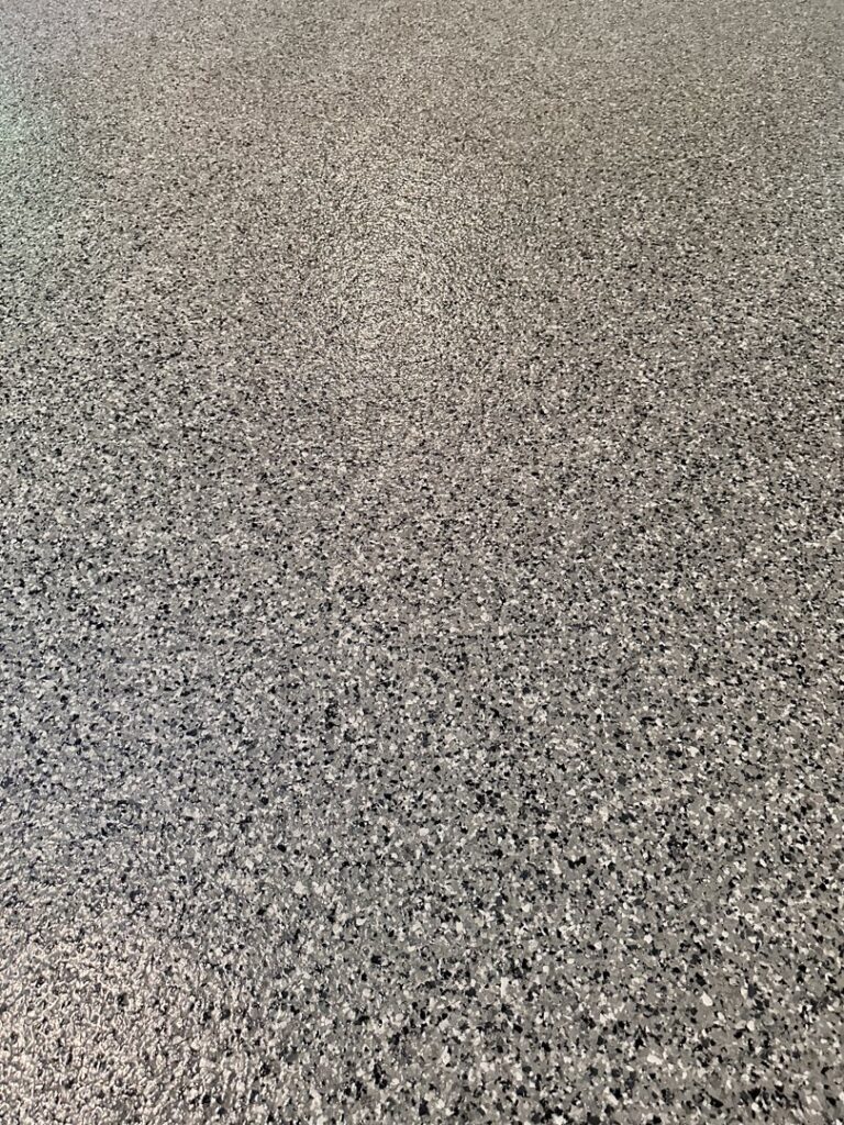 A close-up view of the durable epoxy flake floor texture by Premier Edge Concrete in Grand Rapids, MI