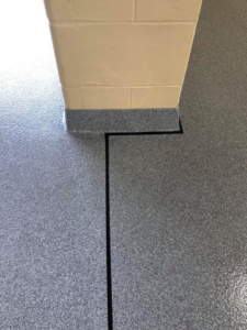 Close-up of a durable speckled grey epoxy floor finish by Blendex Industrial Epoxy Floors in Lindenhurst, NY