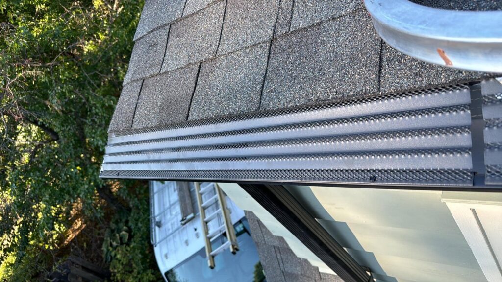 Close-up of a newly installed gutter guard on a residential roof, a handyman service offered by Zamora Roofing & Construction LLC in Madison, WI.