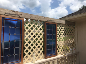 A close-up of newly installed deck lattice and blue decorative panels, completed by Calkins Cabinetry/Handyman's Services in Bentonville, AR.