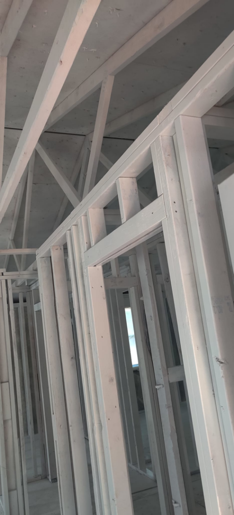 Close-up view of interior wall and ceiling framing during construction by Bernardo Buildings Inc in Virginia Beach, VA.
