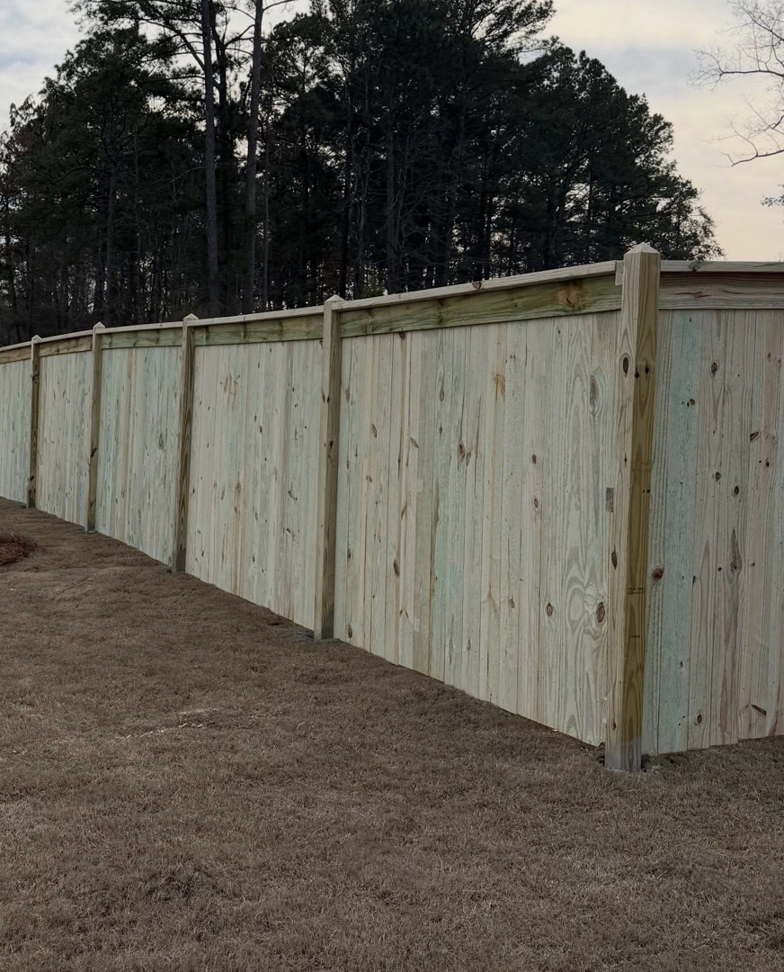 A close-up view of a newly installed wooden privacy fence by Swift Fencing Co. in Birmingham, AL.