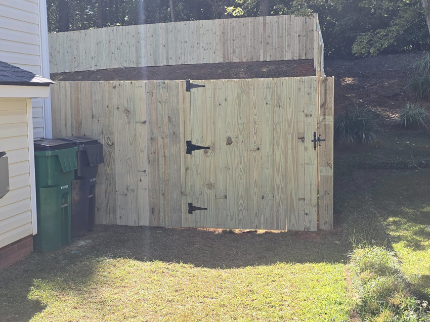 A close-up view of a newly installed wooden privacy fence gate by S&L Decking and Fencing in Charlotte, NC.