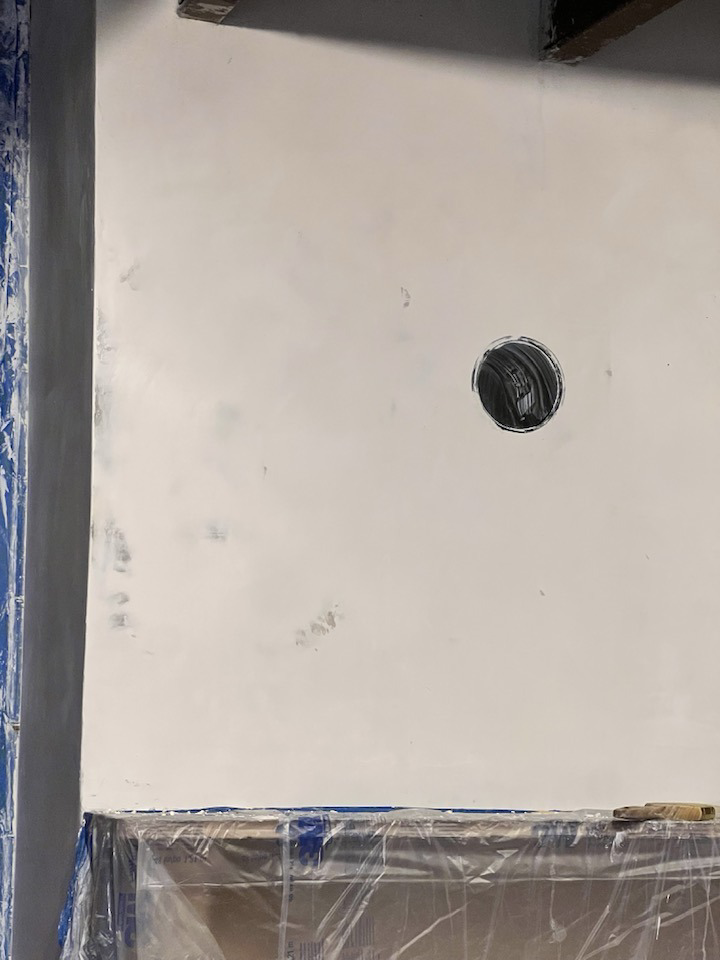 A close-up of a newly plastered wall section with an opening for an electrical outlet by Eric Aulbach Plastering in Saint Louis, MO.