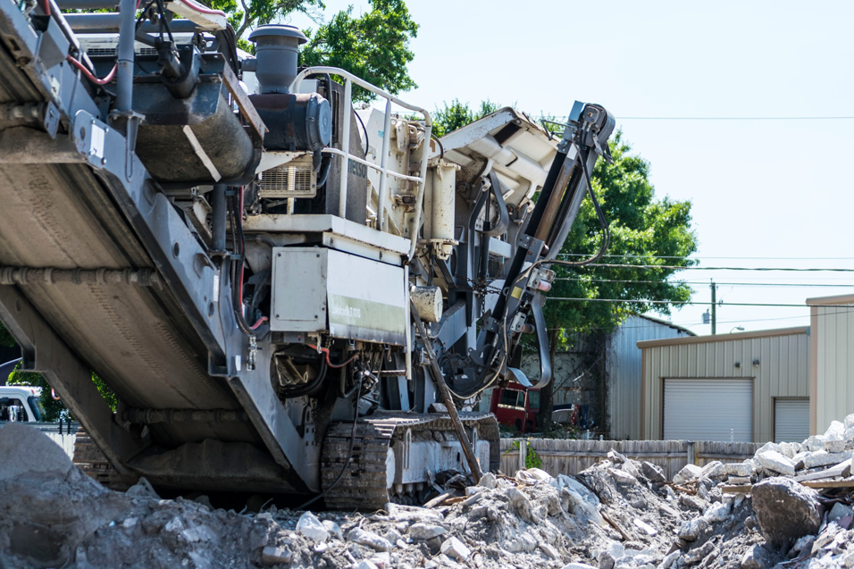 A close-up view of a large debris crushing machine at Global Recycling of Tampa Bay in Tampa, FL.