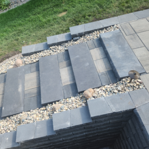 Close-up of detailed paver steps and decorative gravel installed by Great Plains Remodeling and Handyman Services in Mitchell, SD.