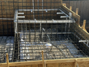 A close-up view of rebar and plumbing installation for a structure by Stealth Civil Contracting in Austin, TX.