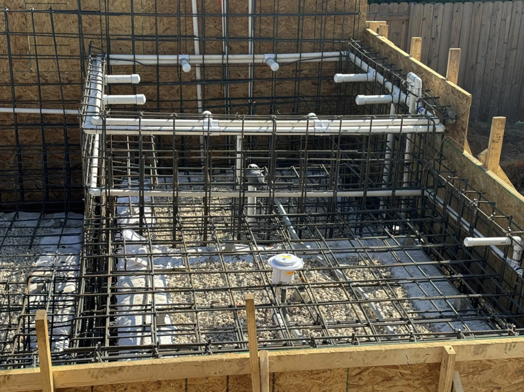 A close-up view of rebar and plumbing installation for a structure by Stealth Civil Contracting in Austin, TX.