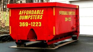 A close-up view of a red dumpster from Affordable Dumpsters, ready for junk removal in Watervliet, NY.