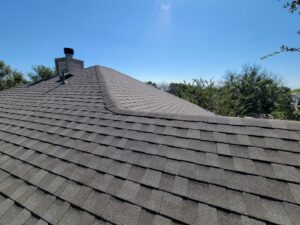 Close-up view of a residential roof with new asphalt shingles installed by Austin Roofing and Construction in Austin, TX.