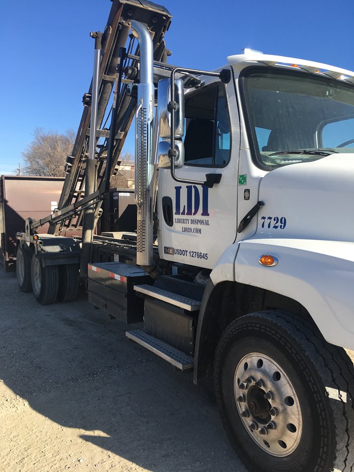 A close-up view of a white LDI roll-off truck, showcasing the equipment of Liberty Disposal, Inc. in Tucson, AZ.