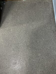 A close-up view of a durable speckled epoxy floor installed by Simply Construction in Las Vegas, NV.
