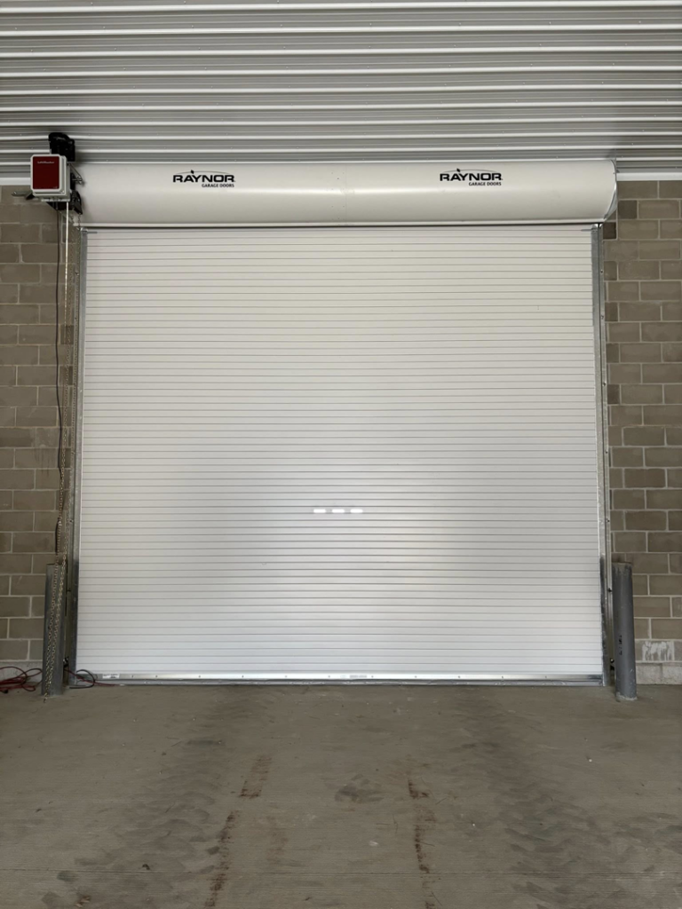 A fully closed Raynor commercial roll-up door installed by Gateway Door and Contracting in House Springs, MO.