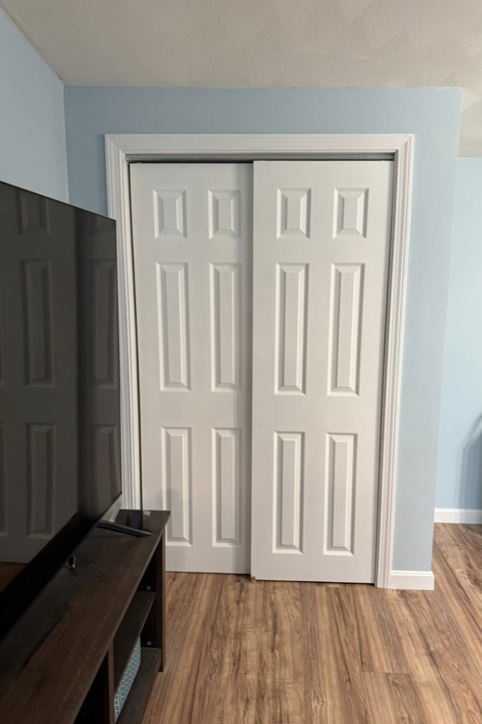 Newly installed white bi-fold closet doors in a home, a service provided by Daniels Handyman Services in Warwick, RI.