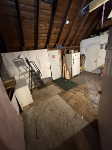 A cluttered attic filled with old furniture and miscellaneous items, ready for junk removal by DJ's Junk Removal in Laconia, NH.