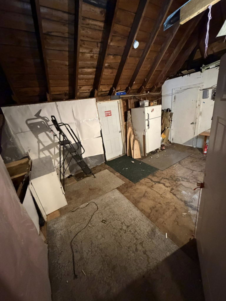 A cluttered attic filled with old furniture and miscellaneous items, ready for junk removal by DJ's Junk Removal in Laconia, NH.