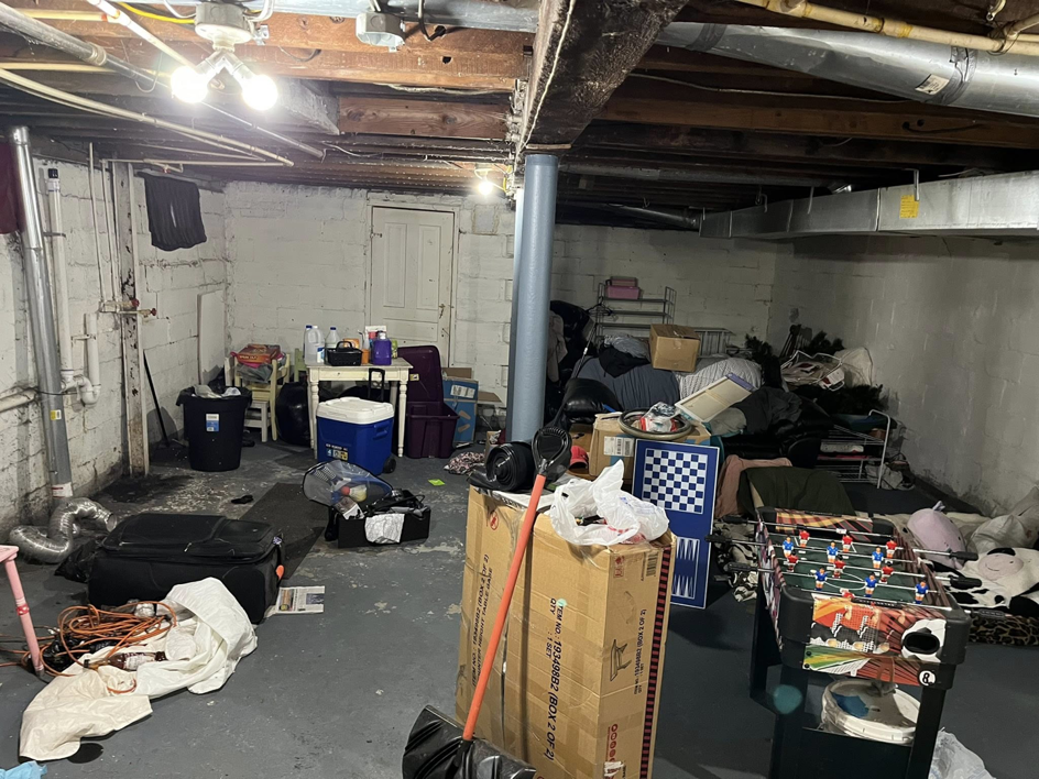 A cluttered basement filled with various items and boxes, ready for removal by 2 Much Junk? Junk Removal in Grand Rapids, MI.