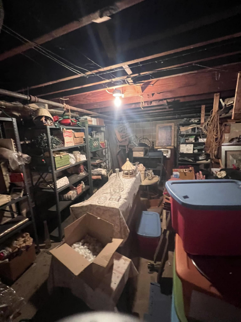 A cluttered basement storage area filled with boxes and items, ready for junk removal by 302-Rid-Junk in Wilmington, DE.